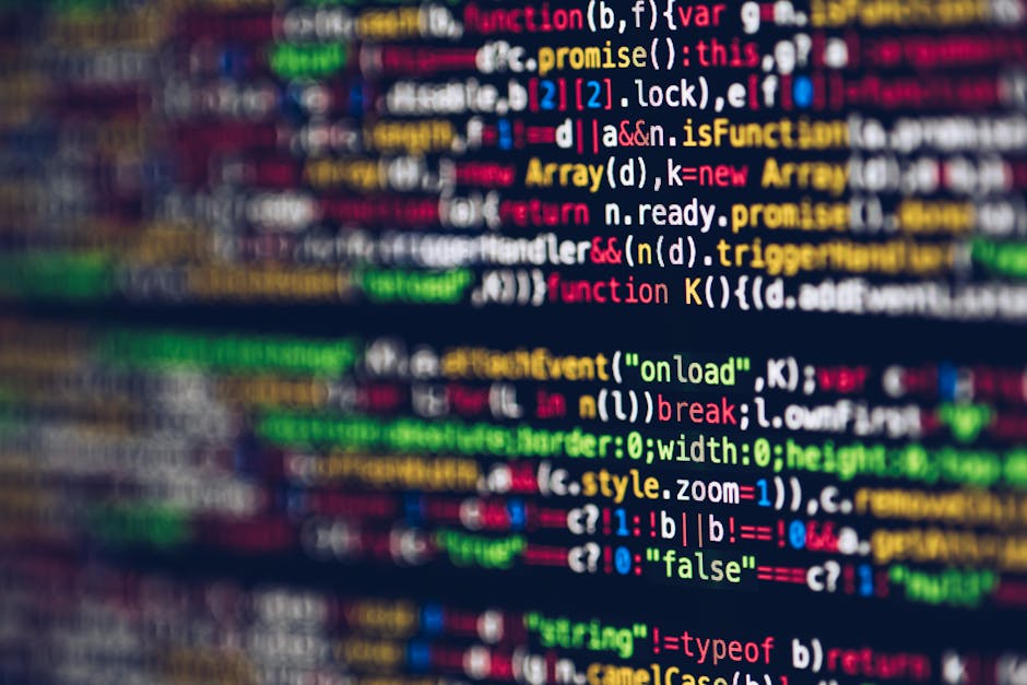A close-up image of a computer screen displaying colorful lines of programming code in various colors including red, green, yellow, blue, and white, with a blurred background. The code features syntax